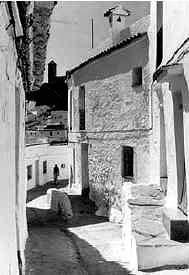 Figure 6: A street in Casares, Andalucia region, Spain. Note the steps to the front doors of the houses on the right are within the fina space of the houses. Photo courtesy: www.justcasares.com